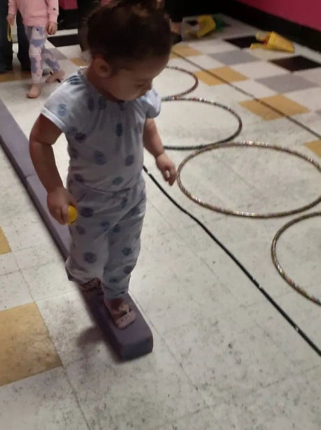 A Tumble Tots student practicing balance